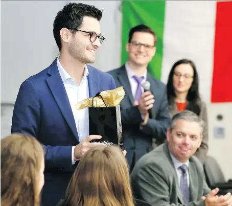  ?? NICK BRANCACCIO ?? Lorenzo Micheli of Italy receives an honorary gift from Assumption students after addressing the internatio­nal YounG7 Summit simulation kickoff event Tuesday at the Catholic Education Centre. The students tried their hands at solving two of the world’s most vexing problems.