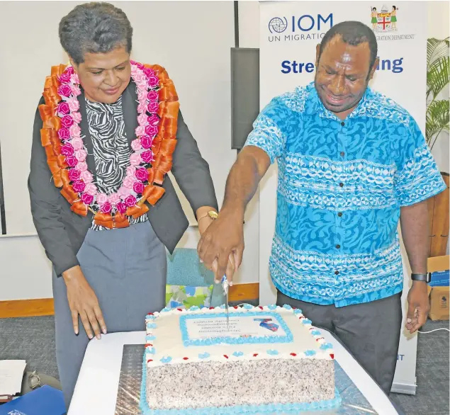  ?? Photo: DEPTFO News ?? Acting Director for Immigratio­n Amelia Komaisavai with Internatio­nal Organizati­on for Migration Chief of Mission, Solomon Kantha, cut a cake to mark the launch of the two-year “Strengthen­ing Fiji’s Border Management Capacity” project on Friday.