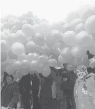  ?? SERGEI SUPINSKY/AFP/Getty Images files ?? Supporters of Viktor Yushchenko carry balloons in Ukraine during the Orange Revolution of December 2004. Russian President Vladimir Putin said Thursday his government must do ‘everything necessary’ to prevent similar events in Russia.
