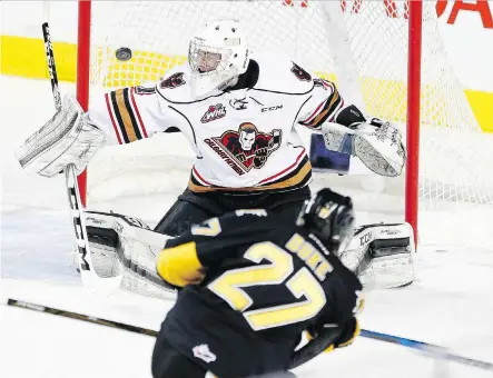 ?? LEAH HENNEL ?? The Brandon Wheat Kings’ Reid Duke scores on Calgary Hitmen goalie Trevor Martin in a WHL game at the Scotiabank Saddledome on Sunday. Duke, a Calgary native, scored four goals in Brandon’s 6-1 victory to keep the Hitmen one point out of a playoff...
