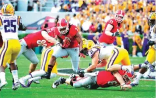  ??  ?? ATHENS: Todd Gurley No. 3 of the Georgia Bulldogs carries the ball against the LSU Tigers at Sanford Stadium. —AFP