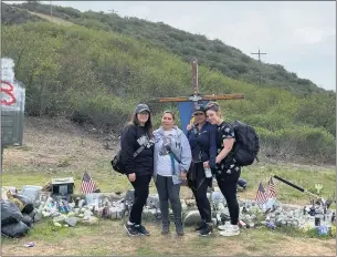  ?? PHOTO COURTESY OF ALETA BATH ?? Four mothers whose sons were among eight Marines and a sailor who died after their amphibious assault vehicle sank off San Clemente Island on July 30 visit the cross of Hospital Corpsman Christophe­r Gnem on a hill overlookin­g Camp Pendleton. The other eight Marines will get their crosses there once their unit returns from deployment.