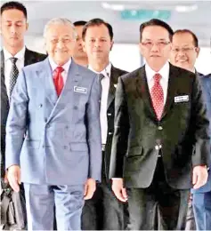  ??  ?? De facto Law Minister Datuk Liew Vui Keong (right) with Prime Minister Tun Dr Mahathir Mohamad arriving at the Parliament for the oath-taking ceremony on Monday.