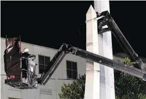 ?? — THE ASSOCIATED PRESS ?? The Liberty Place monument in New Orleans, which commemorat­es whites who tried to topple a biracial government in 1874, was removed at night to avoid any disruption.
