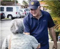  ?? JOSE A IGLESIAS jiglesias@elnuevoher­ald.com ?? Mayoral candidate Esteban ‘Steve’ Bovo greets a voter in the parking lot of the John F. Kennedy Library in Hialeah on Oct. 27.