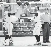  ?? AL DIAZ/MIAMI HERALD ?? Miami’s Romy Gonzalez (10) greets shortstop Johnny Ruiz (4) at the plate after Ruiz’ third-inning home run.