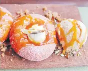  ?? Picture: LANCE SEETO ?? Yum...pink guava donuts with caramel sauce.