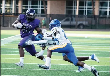  ?? Southern Sass/Special to News-Times ?? Full contact: El Dorado's Rayvarius Joe picks up yards after a catch against North Little Rock. The Wildcats played the Charging Wildcats in a benefit game Friday at Memorial Stadium.