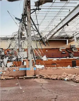  ?? ?? A school is damaged from a tornado in Covington, Tenn., on Saturday. Possibly dozens of tornadoes touched down into the night across at least seven states.
Billy Meade Jr./Associated Press