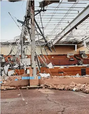  ?? ?? A school is damaged from a tornado in Covington, Tenn., on Saturday. Possibly dozens of tornadoes touched down into the night across at least seven states.
Billy Meade Jr./Associated Press