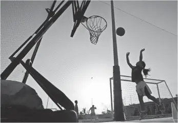  ?? HASAN JAMALI, AP ?? A girl shoots baskets at a private sports club in Jiddah, Saudi Arabia.