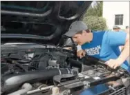  ?? PETE BANNAN – DIGITAL FIRST MEDIA ?? Make-A-Wish recipient Levi King, 18, checks under the hood of his dream truck makeover from Malvern areabased Turn5.