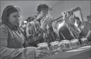  ?? The Associated Press ?? PERMISSION: Customers, left to right, Alli Bertucci, Patrick Bean, and Ali Regan shop Friday for marijuana inside the retail store at 3D Cannabis Center, in Denver. The marijuana industry breathed a sigh of relief Friday after federal banking...