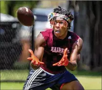  ?? RICHARD GRAULICH / PALM BEACH POST ?? Glades Central senior Ja’Vontae Williams, 18, makes a catch Friday in the T.E.A.M. Elam Foundation 7-on-7 Championsh­ip at the Wells Recreation Center in Riviera Beach.
