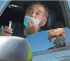  ?? DAVID WALLACE/USA TODAY NETWORK ?? Lupe Lopez, 80, of Phoenix puts a testing stick into his nasal cavity in Phoenix on July 17.