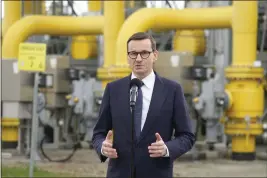  ?? CZAREK SOKOLOWSKI — THE ASSOCIATED PRESS ?? Poland's Prime Minister Mateusz Morawiecki speaks to the media at a natural gas transmissi­on facility in Rembelszcz­yzna, near Warsaw, Poland, on Wednesday.