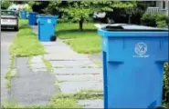  ?? FILE PHOTO BY TONY ADAMIS ?? Single-stream recycling totes are lined up for collection on a sidewalk in Kingston, N.Y.