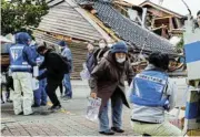  ?? /Reuters ?? Aftermath: People line up in Wajima, Japan, to collect water after the New Year’s Day earthquake.
