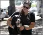  ?? BILL UHRICH — MEDIANEWS GROUP ?? Grey Muzzle Manor’s Marcy Tocker of Mohrsville with Emmett the therapy dog at the fifth annual Hops for Hooves fundraiser at Willow Glen Park in Sinking Spring on Saturday.