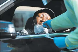  ?? STACEY WESCOTT/CHICAGO TRIBUNE ?? Geraldine Goss, of Oak Park, gets her first COVID-19 test at a rapid testing location at First Presbyteri­an Church onWednesda­y in River Forest.