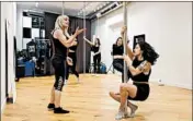  ?? BRIAN CASSELLA/CHICAGO TRIBUNE ?? Patty Yaconis, left, instructs Mazerati Cevallos during a pole dancing class on Feb. 6 at Pole Appeal in Lakeview.