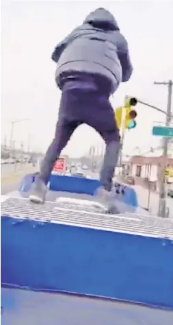  ?? ?? TAKING A STUPID STAND: A daredevil balances on top of a moving MTA bus, part of a trend inspired by subway surfing — itself a dangerous social-media stunt that has led to the deaths of two people this year.