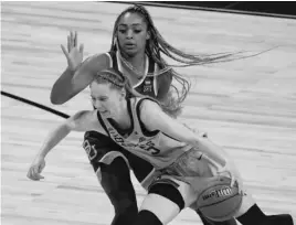  ??  ?? MORRY GASH/AP UConn’s Paige Bueckers drives past Baylor’s DiJonai Carrington during the second half of their regional championsh­ip game Monday.