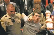  ?? JOHN LOCHER/ASSOCIATED PRESS ?? Police remove Michael Steven Sandford as Republican presidenti­al candidate Donald Trump speaks at the Treasure Island hotel and casino in Las Vegas.