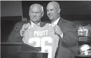  ??  ?? Tennessee football coach Jeremy Pruitt, right, receives a personaliz­ed jersey from athletic director Phillip Fulmer during his introducto­ry news conference in Knoxville, Tenn., on Dec. 7, 2017. Tennessee fired Pruitt on Monday. The university also announced that Fulmer will retire as athletic director. [AP PHOTO/STEVE MEGARGEE, FILE]