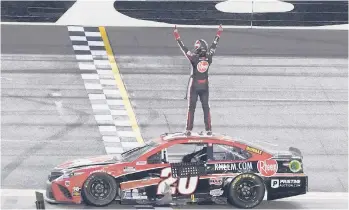  ?? JOHN RAOUX/AP ?? Christophe­r Bell celebrates Sunday after winning NASCAR’s road course race at Daytona Internatio­nal Speedway. It was Bell’s first career Cup victory.