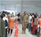  ?? DAVID GOLDMAN/AP ?? Afghan refugees line up last week for food at Fort Bliss’ Doña Ana Village, where they are being housed in Chaparral, N.M.