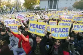  ?? THE ASSOCIATED PRESS ?? Ant-war protesters hold up their cards during a rally demanding peace of the Korean peninsula near U.S. Embassy in Seoul, South Korea, Sunday.