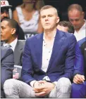  ?? Noah K. Murray / Associated Press ?? Knicks forward Kristaps Porzingis sits on the bench during the second quarter of the team’s preseason game against the Nets on Oct. 3.