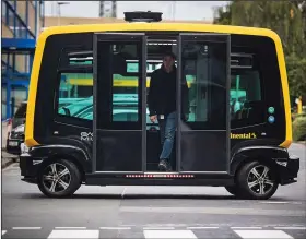  ?? Bloomberg/ANDREAS ARNOLD ?? A rider emerges from from a Cube self-driving taxi last September in Frankfurt, Germany.
