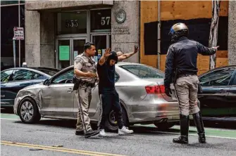  ?? ?? CHP officers M. Garcia (left) and J.Robrecht pull over a man for suspected drunken driving in the Tenderloin in San Francisco. Critics say the agency is making an end-run around local police.