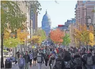  ?? MIKE DE SISTI/MILWAUKEE JOURNAL SENTINEL ?? Students walk to classes on campus along State Street with the State Capitol in the background at the University of Wisconsin-Madison on Oct. 23, 2019.