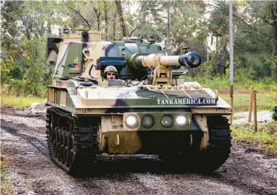  ?? PATRICK CONNOLLY/ORLANDO SENTINEL ?? Visitors can get behind the controls of a 17-ton FV433 Abbot tank at Tank America in Orlando, pictured on Thursday.