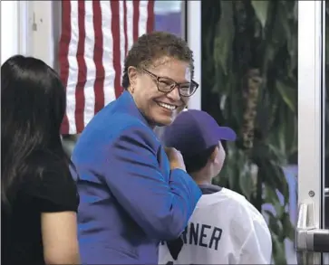  ?? Christina House Los Angeles Times ?? REP. KAREN BASS leaves a polling place in June. Bass was granted an exemption by the House ethics panel to the rule prohibitin­g gifts to members of Congress, and says the scholarshi­p played no role in policymaki­ng.