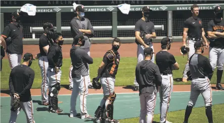  ?? Photos by Stephen Lam / Special to The Chronicle ?? Catcher Buster Posey (wearing gear, facing) and his teammates took part in the Giants’ workout at Oracle Park on Monday.