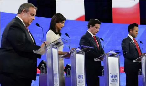  ?? Gerald Herbert/Associated Press ?? Republican presidenti­al candidates from left, former New Jersey Gov. Chris Christie, former U.N. Ambassador Nikki Haley, Florida Gov. Ron DeSantis, and businessma­n Vivek Ramaswamy during a Republican presidenti­al primary debate Wednesday evening, hosted by NewsNation, at the Moody Music Hall at the University of Alabama in Tuscaloosa, Ala.