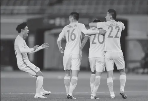  ??  ?? China striker Wei Shihao (second from right) celebrates scoring the opening goal with his teammates against South Korea at the East Asian Cup soccer tournament on Saturday in Tokyo, Japan.