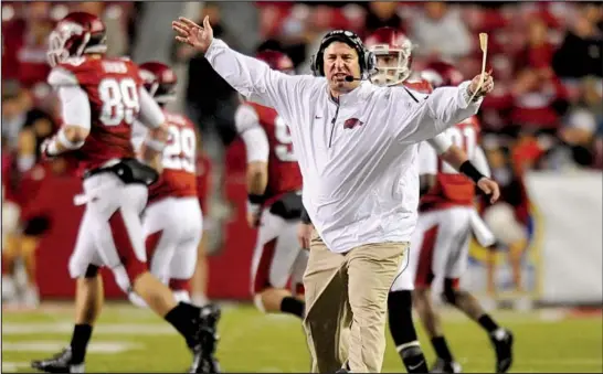  ?? NWA Media/MICHAEL WOODS ?? Arkansas Coach Bret Bielema threw his arms up in dismay on numerous occasions during his first season, which ended with a nine-game losing streak and a 3-9 record. But Bielema says the Razorbacks are on track to accomplish what he came to Fayettevil­le...