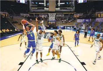  ?? GREGORY SHAMUS GETTY IMAGES ?? Jaime Jaquez Jr. (4) of UCLA goes up for two of his career-high 27 points in Thursday’s First Four game.