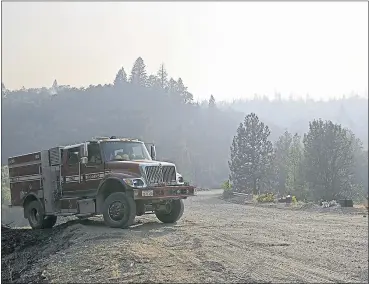  ?? JOSE CARLOS FAJARDO — STAFF PHOTOGRAPH­ER ?? A fire truck pulls over while battling the Ranch Fire, part of the Mendocino Complex Fire, in Mendocino National Forest.