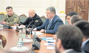  ?? AFP ?? Ukraine’s President Petro Poroshenko, centre, leads a session of the National Security and Defence Council of Ukraine yesterday.