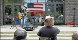  ??  ?? Former state Rep. Brian Mattiello entertains the crowd singing cover songs at Coe Memorial Park at the first-ever Saturday in the Park event in Torrington on Saturday.