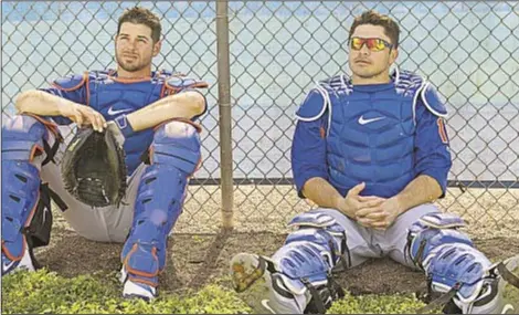  ??  ?? While GM Sandy Alderson is not on the fence about his two catchers, Kevin Plawecki (l.) and Travis d'Arnaud, Hall of Famer Mike Piazza issues challenge to Mets’ backstops to step up their game. HOWARD