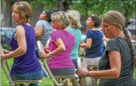  ?? DIGITAL FIRST MEDIA FILE PHOTO ?? Before moving to Texas, former North Coventry resident Barbara Kosciewicz, right, owned High Street Yoga Studio and gave outdoor demonstrat­ions at the Smith Family Plaza in Pottstown.