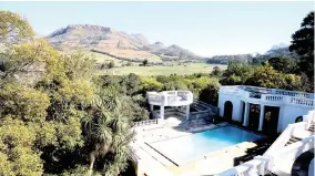  ??  ?? The swimming pool and scenic surrounds of the Constantia mansion on offer from Rawson’s on July 29.