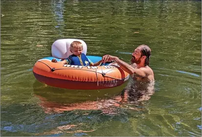  ?? JAKE HUTCHISON — CHICO ENTERPRISE-RECORD ?? Wyatt and Nick Wahl-Adams cool off in the water of Sycamore Pool on Friday in Chico.